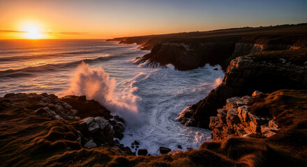 Obraz premium Waves crash against the rocky coast at sunset, creating a dramatic display of natures power and beauty