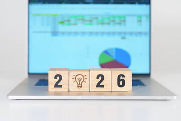 2026 Year block with lightbulb icon against computer laptop background. Business Idea, Creative, Thinking, brainstorm, Goal, Resolution, strategy, plan, Action, change and New Year start concepts