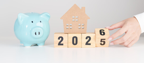 Happy New Year 2026 with house model and Coins stack. real estate, Home loan, tax, investment, mortgage, financial, savings and New Year Resolution concepts