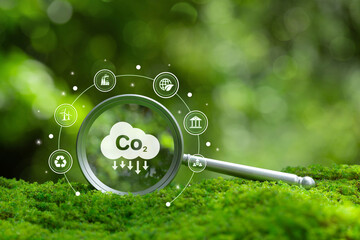 Naklejka na ściany i meble Magnifying glass focusing on CO2 icon with green environment background symbolizes carbon footprint analysis, emission reduction, sustainability, ESG data, and eco-friendly business solutions. Naklejka na ściany i meble Magnifying glass focusing on CO2 icon with green environment background symbolizes carbon footprint analysis, emission reduction, sustainability, ESG data, and eco-friendly business solutions.