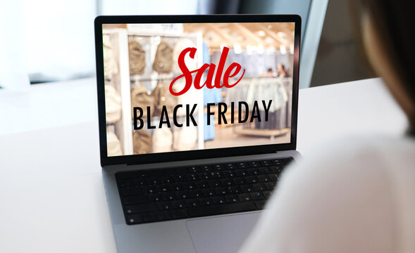 Woman hands typing laptop computer with black friday sale web banner on screen background, Online shopping sale, business and technology