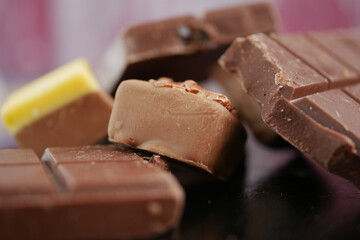 Chocolate pieces arranged on a dark surface