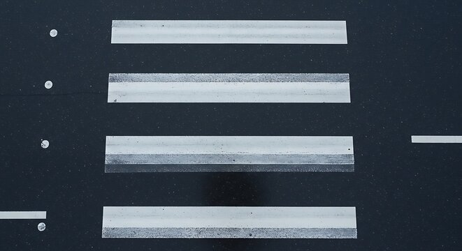 Crosswalk on Dark Asphalt from Aerial View