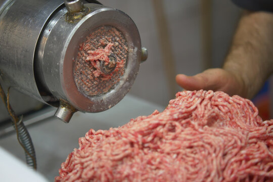 Ground meat being processed at a local market