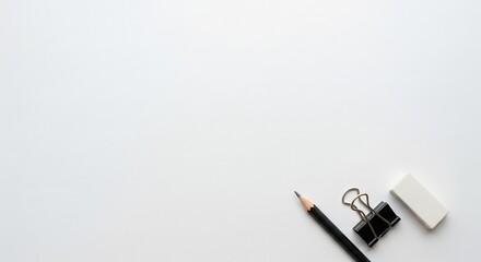 Professional pencil, binder clip, and eraser neatly arranged on a clean white background, perfect for study or office projects.