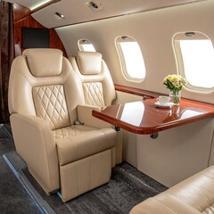 Luxurious private jet cabin with seats and table