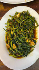 fried morning glory with crispy pork stir fried water spinach.	
