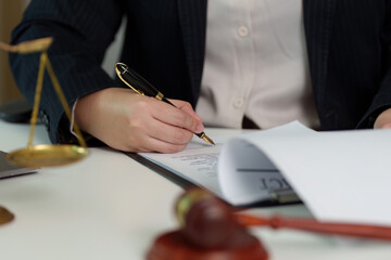 Lawyer Writing on Legal Document with Gavel