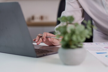 Digital Workspace. Professional using laptop for data analysis and reporting.