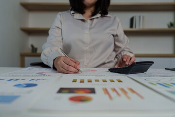 Comprehensive Review. Professional analyzing financial data with calculator and pen.