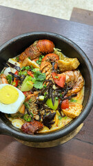 Lobster Tom yum spicy rice noodles claypot	
