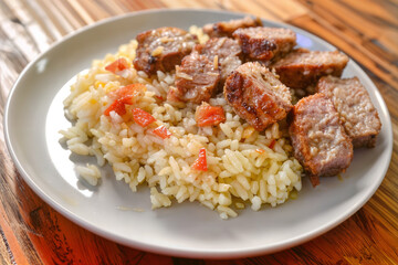 Asian-style dish of rice with braised meat, green onions, and fresh sprouts on top.