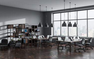 Spacious modern coworking office interior with large windows, sleek furniture, and bookshelf decor in a professional environment. 3D Rendering