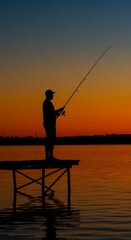 Silhouette of a lone fisherman casting his line from a wooden pier at sunset.