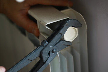 Repairing Radiator with Adjustable Wrench: Hands-On Home Maintenance Tool and Technique