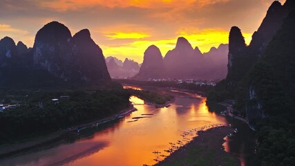 Aerial shot of the beautiful river and spectacular Karst mountain natural landscape at sunset in Guilin, China.