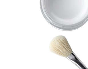 A makeup brush and a round cosmetic container.