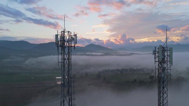 Aerial View of Tower Antenna Telecommunication Cell Phone, Two brothers telecom tower in the midst of foggy cloud in morning. 
