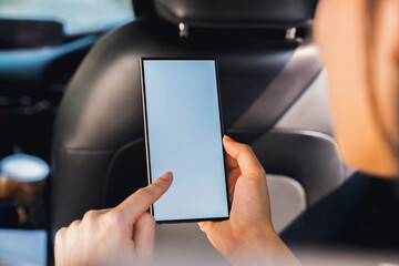 Woman sitting in a private car and hand holding smartphone mockup of blank screen, Take your screen to put on advertising