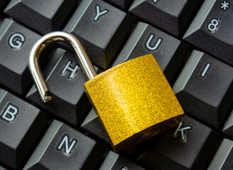 Top view of padlock on keyboard background symbolizing restricted entry, secure login or digital safety system.