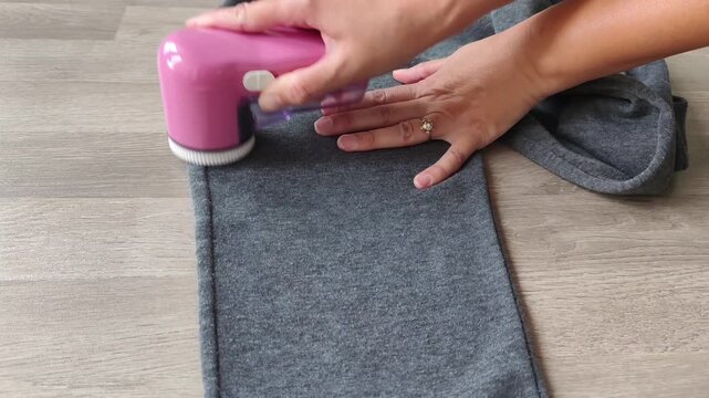 Modern fabric shaver to remove lint and pills . High quality 4k footage