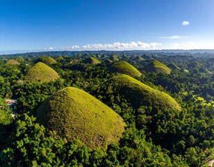 Fototapeta premium Aerial shot of unique, verdant, cone-shaped hills under a clear blue sky