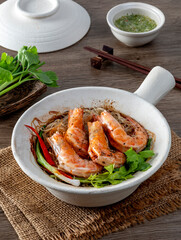 Baked shrimp with glass noodles on a wooden table