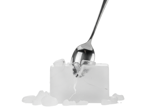 Metal spoon is cracking a large block of clear ice into pieces on a transparent background