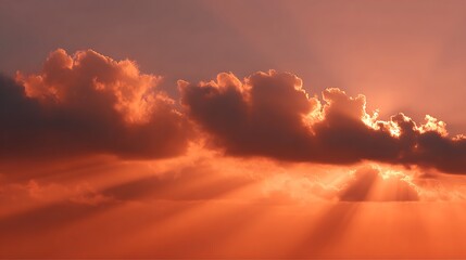 Dramatic sunset clouds glowing orange with beams of light shining down