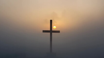 Sun peeking behind metal cross and climbing above crossbar over foggy hilltop, illuminating mist - Powered by Adobe