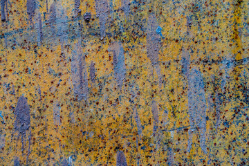 Colorful abstract wall texture found in urban area during daylight, showcasing unique patterns and hues