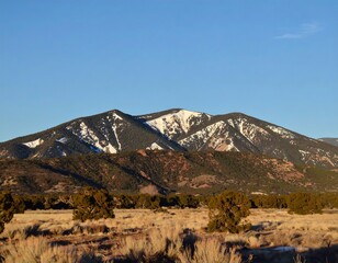 Majestic Mountain Vista - A Landscape of Snow-Capped Peaks and Clear Blue Skies.