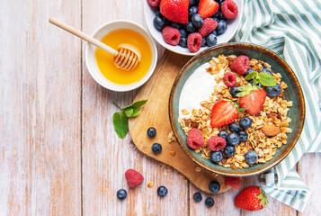 Healthy breakfast granola with fresh berries and honey