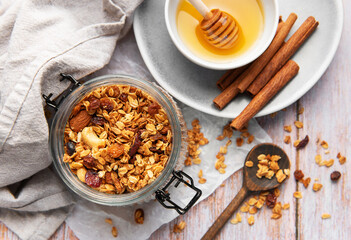 Granola in jar with honey and cinnamon