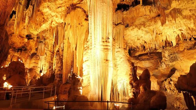Slow tilt up showcasing a big rock inside the Luray Caverns