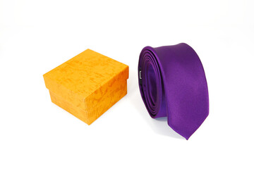 Rolled tie with gift box closeup view on white background 