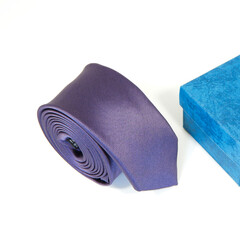 Rolled black tie isolated on white background close-up view 