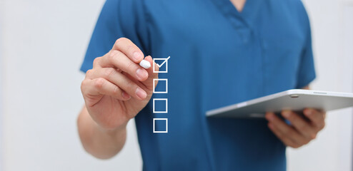 close up young general practitioner hand use stylus pen to check box on medical chekclist or opd record to read and diagnose and assess about patient's symptom for healthy and lifestyle concept
