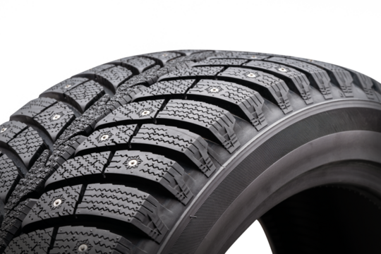 Close-up view of winter studded tire showcasing tread pattern and seasonal design on a white background for effective sales presentation