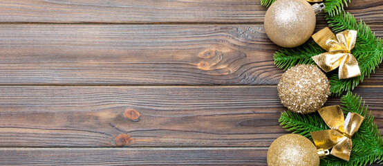 Set of festive balls, fir tree and Christmas decorations on wooden background. Top view of New Year...