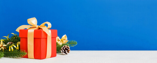 New Year Christmas mood, gift box, branches of a christmas tree, New Year decorations on a colored...