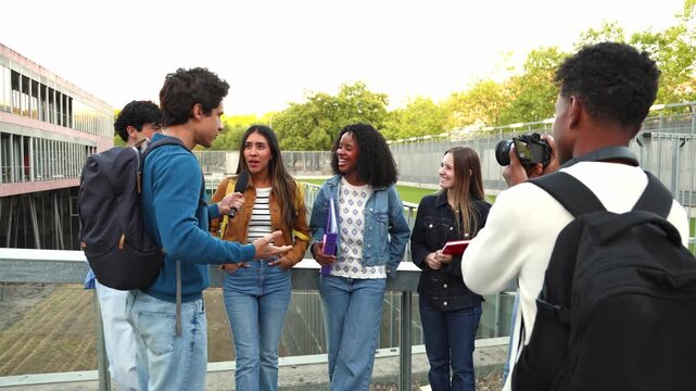 Young student presenter interviewing classmates on university campus