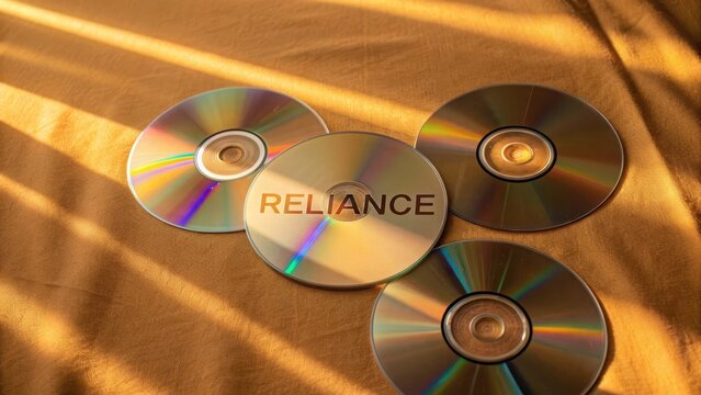 A flat view of Reliance text on CDs reflecting light