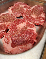 Marbled ribeye steaks promise succulent indulgence, invoking carnivorous rituals and BBQ festivities under the smoky harvest moon