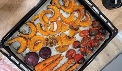 Vibrant autumnal vegetables roasted for Samhain feast, featuring pumpkin crescents and tomato medley, celebrating harvest's vibrant palette