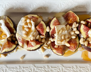 Juicy figs oozing with honey and creamy Brie, sprinkled with pine nuts, evoke Mabon harvest festivals and gourmet decadence