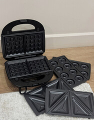 Waffle iron with interchangeable plates, breakfast labyrinth reveals cozy brunch potential, ideal...