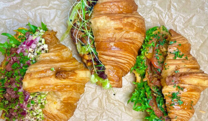 Crisp buttery croissants cradle vibrant microgreens and tangy delights, perfect for Bastille Day...