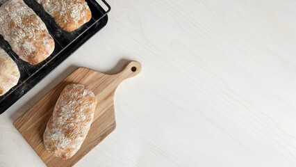 Golden ciabatta loaves rest like rustic artifacts, evoking Lammas harvest celebration and National Sourdough Bread Day anticipation