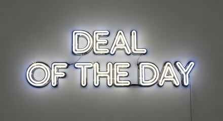 White neon sign reading deal of the day glowing on gray wall, concept of promotion, marketing advertisement, and retail offer.
